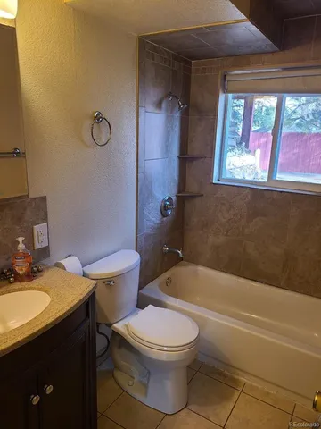 a bathroom with a sink a toilet and tub