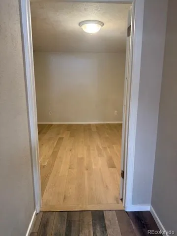 an empty room with wooden floor