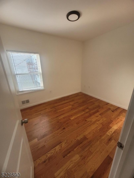 452 Fulton Street, Unit 1 Elizabeth Port, NJ 07206 - Photo 4 of 12 an empty room with windows