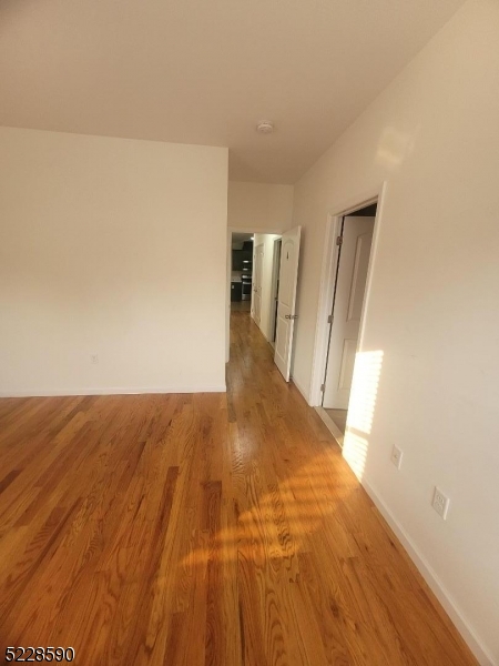 452 Fulton Street, Unit 1 Elizabeth Port, NJ 07206 - Photo 8 of 12 a view of a big room with wooden floor and staircase