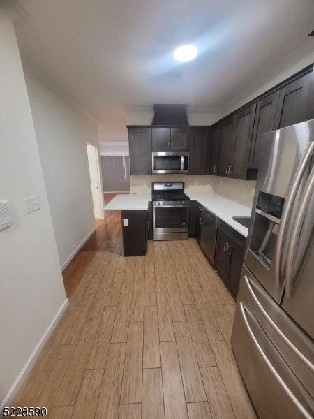 452 Fulton Street, Unit 1 Elizabeth Port, NJ 07206 - Photo 10 of 12 a kitchen with stainless steel appliances a stove a sink and a refrigerator