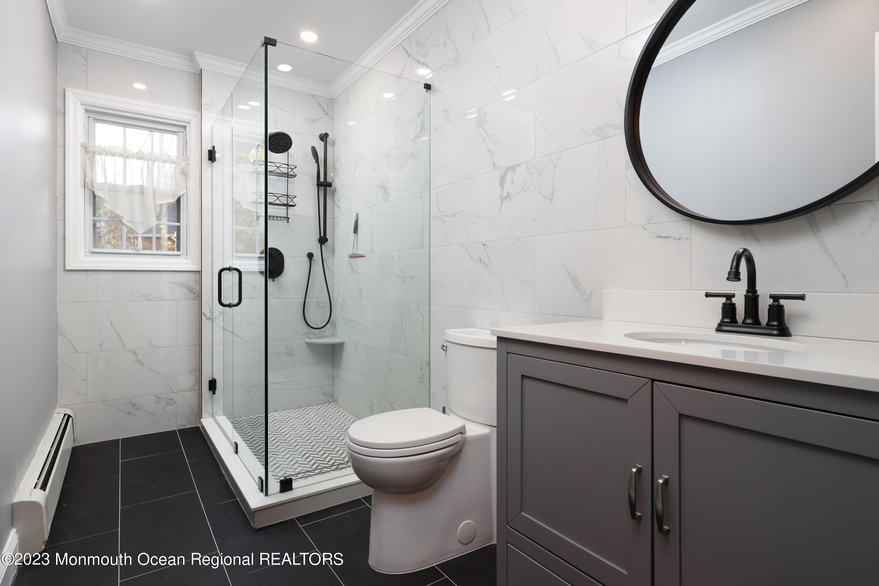 2600 Logan Road Asbury Park, NJ 07712 - Photo 21 of 36 a bathroom with a sink a toilet and shower