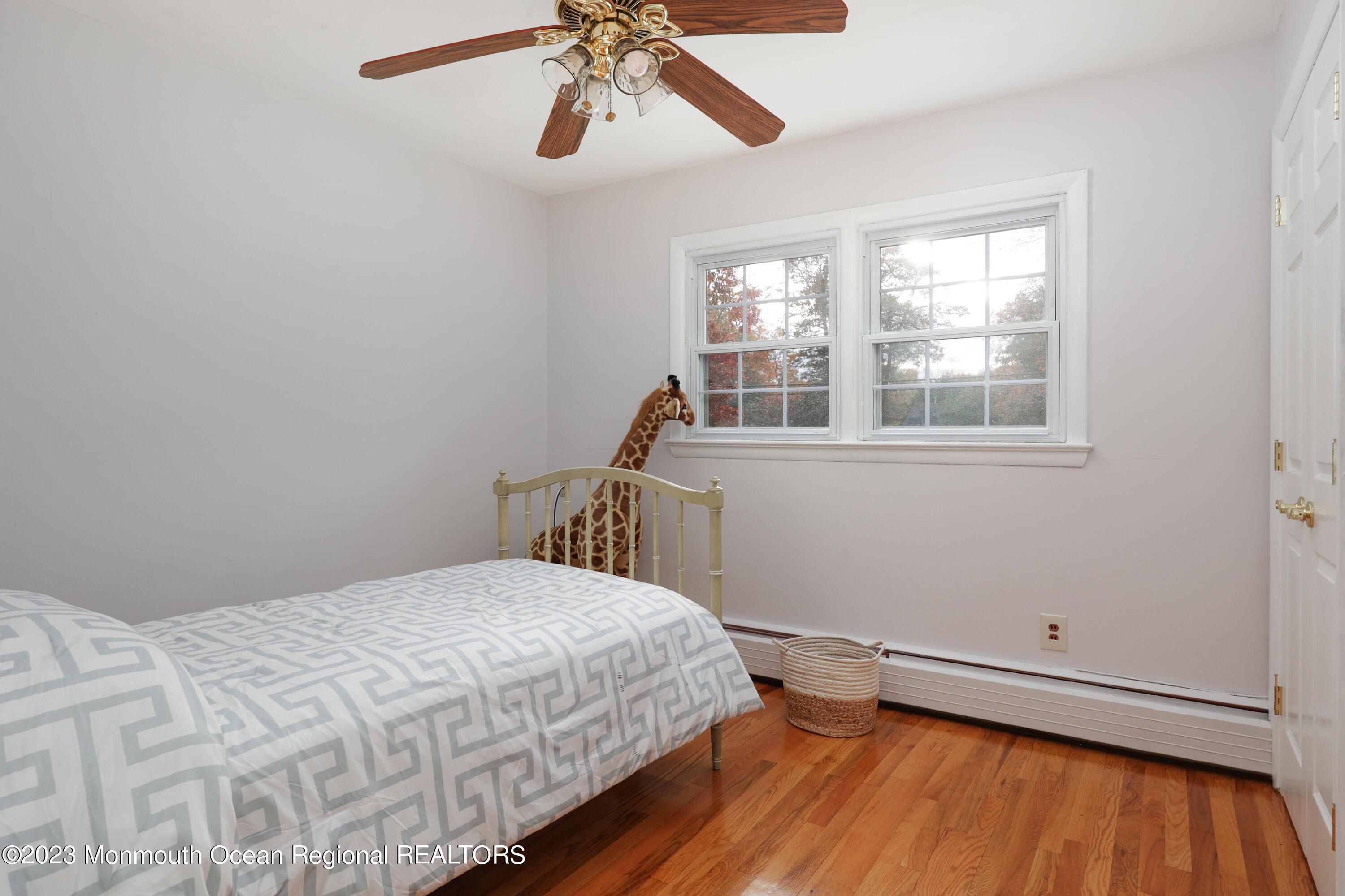 2600 Logan Road Asbury Park, NJ 07712 - Photo 23 of 36 a bedroom with a bed and a wooden floor