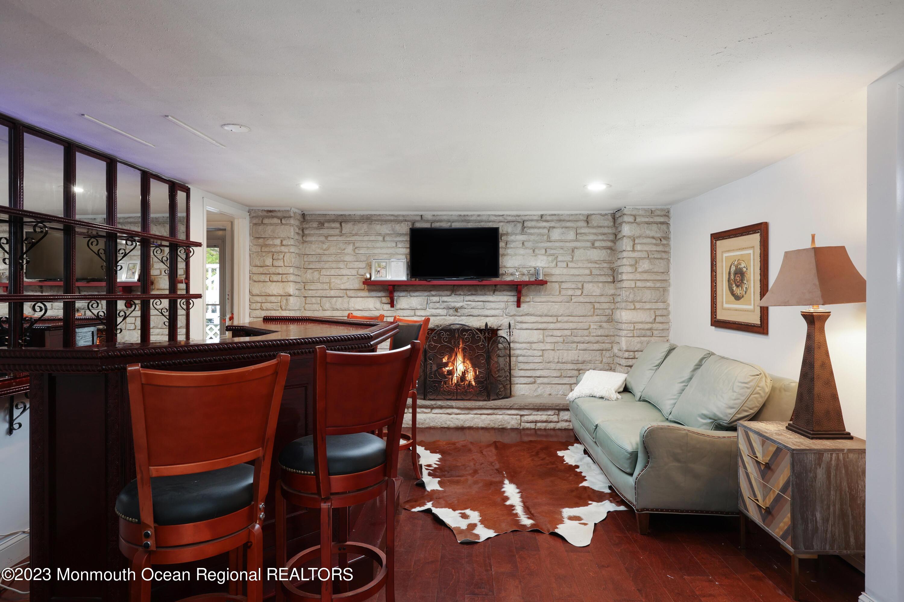 2600 Logan Road Asbury Park, NJ 07712 - Photo 25 of 36 a living room with furniture a flat screen tv and a fireplace