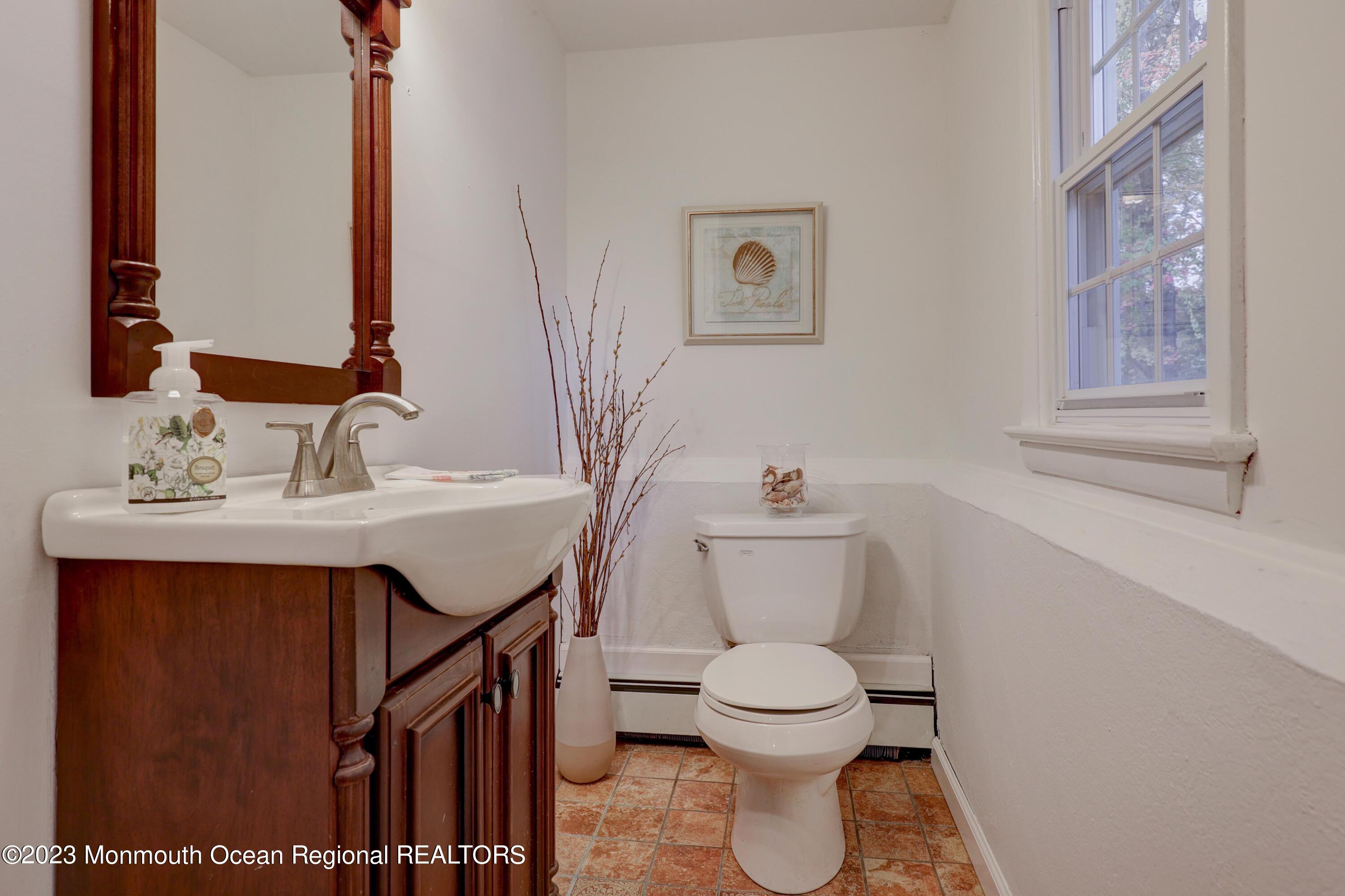 2600 Logan Road Asbury Park, NJ 07712 - Photo 26 of 36 a bathroom with a sink toilet and mirror