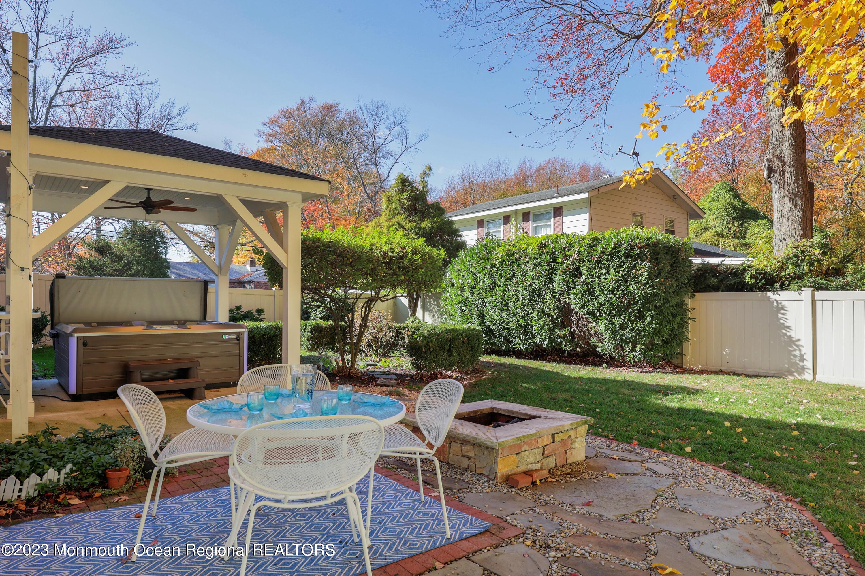 2600 Logan Road Asbury Park, NJ 07712 - Photo 28 of 36 a view of a patio with table and chairs potted plants and a large tree