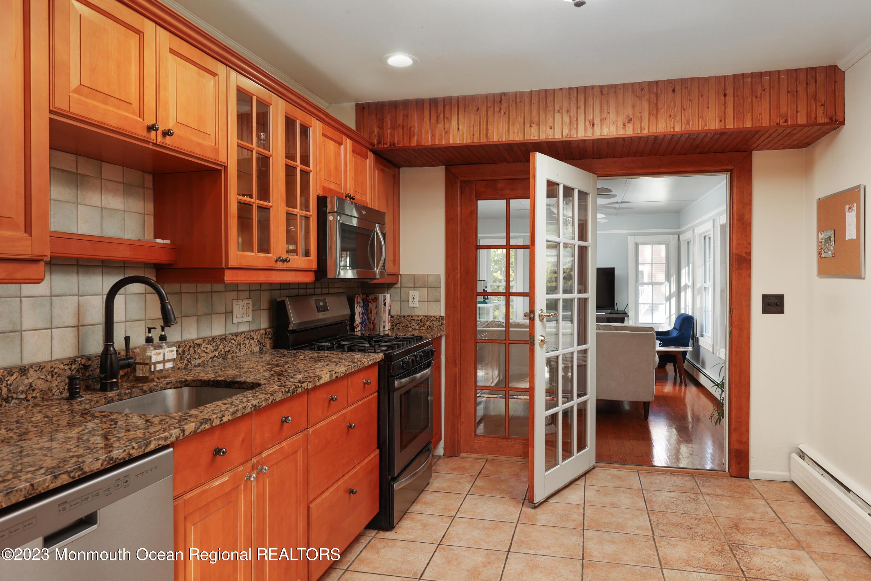 2600 Logan Road Asbury Park, NJ 07712 - Photo 9 of 36 a kitchen with stainless steel appliances granite countertop a stove a sink and a microwave