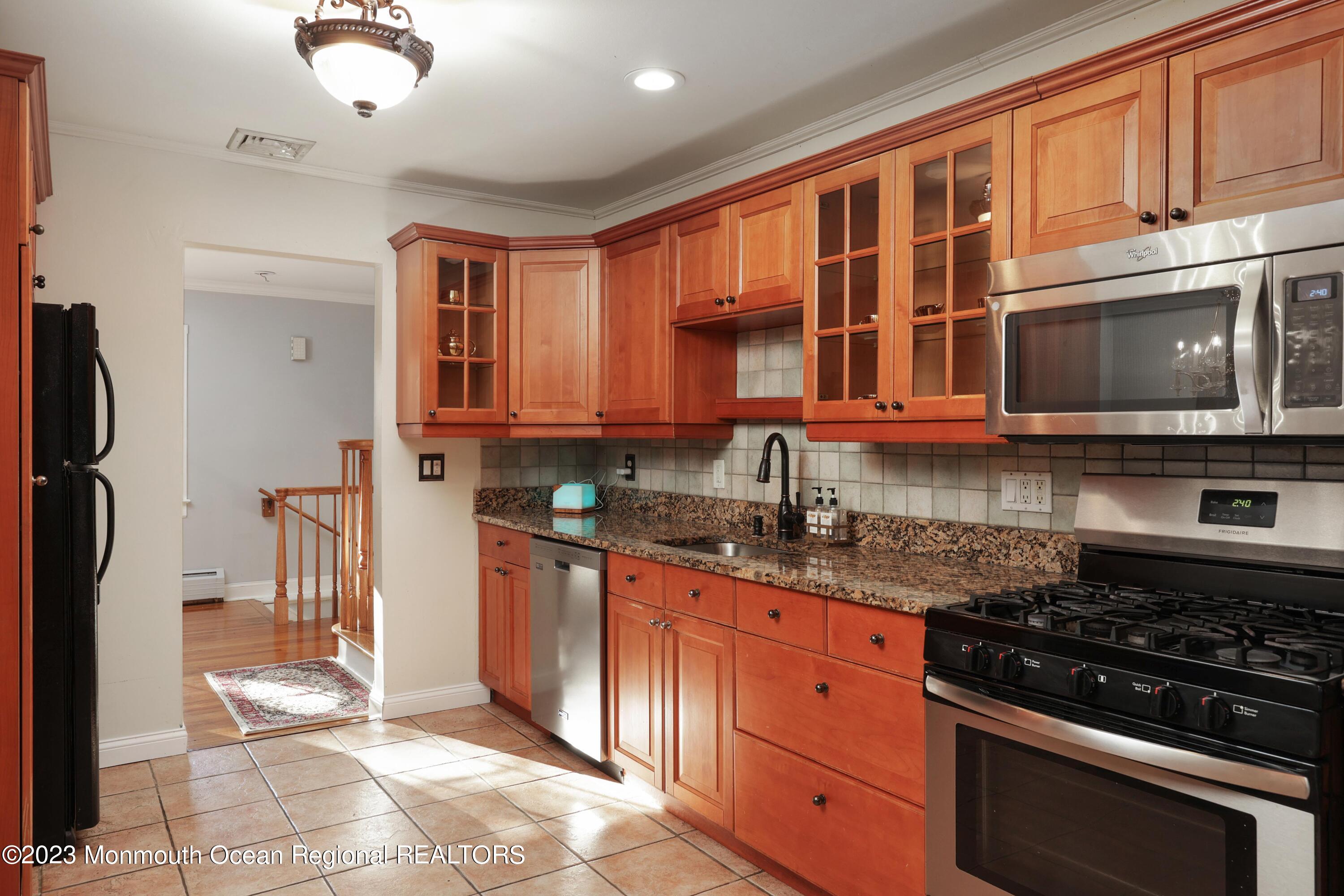 2600 Logan Road Asbury Park, NJ 07712 - Photo 10 of 36 a kitchen with stainless steel appliances granite countertop a stove and a microwave