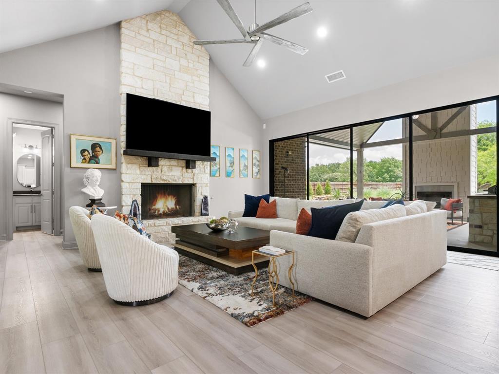 111 Old Base Road Aurora, TX 76078 - Photo 7 of 38 Large living room featuring luxury vinyl plank flooring, abundant natural light, and a dramatic oversized sliding glass door.