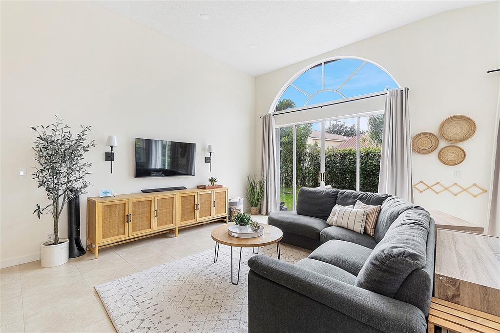 10650 Northwest 48th Street Coral Springs, FL 33076 - Photo 12 of 37 a living room with furniture and a flat screen tv