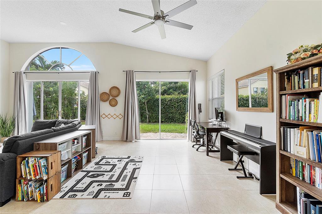 10650 Northwest 48th Street Coral Springs, FL 33076 - Photo 15 of 37 a view of a workspace with furniture and a book shelf