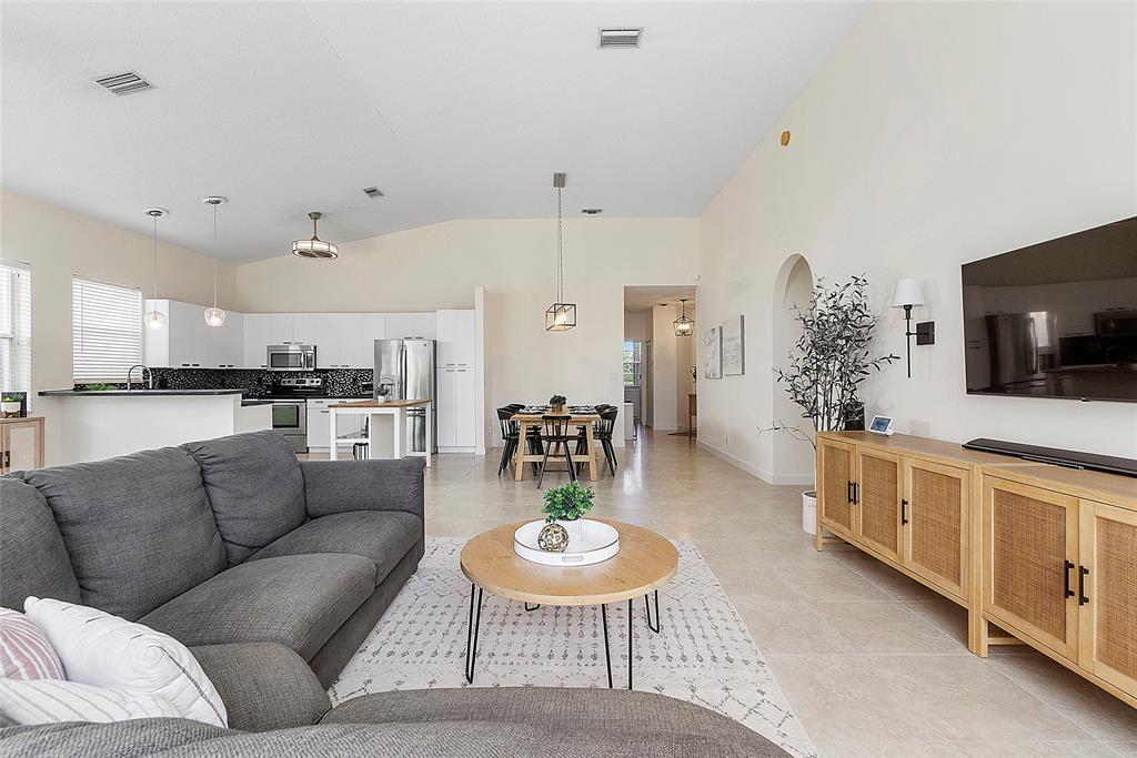 10650 Northwest 48th Street Coral Springs, FL 33076 - Photo 16 of 37 a living room with furniture and a flat screen tv