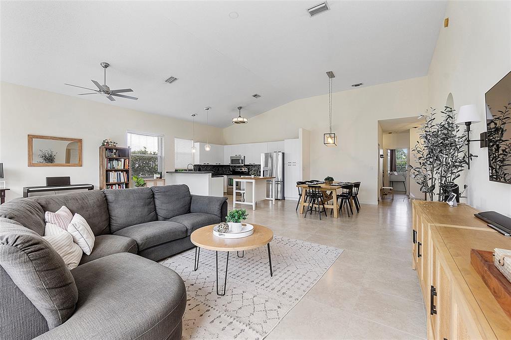 10650 Northwest 48th Street Coral Springs, FL 33076 - Photo 17 of 37 a living room with furniture kitchen view and a potted plant