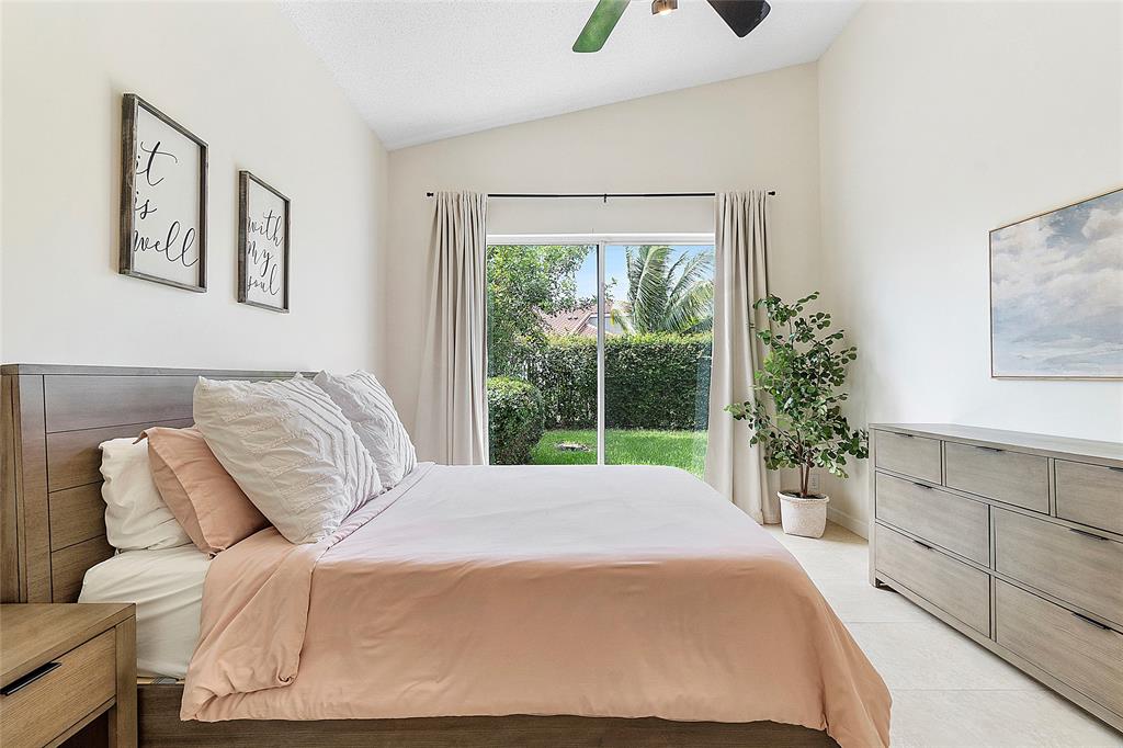 10650 Northwest 48th Street Coral Springs, FL 33076 - Photo 20 of 37 a bedroom with a large bed and a large window