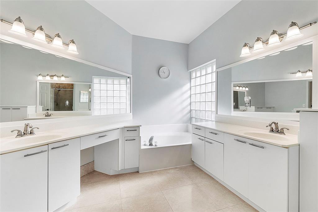 10650 Northwest 48th Street Coral Springs, FL 33076 - Photo 22 of 37 a bathroom with a sink double vanity granite tub and a mirror