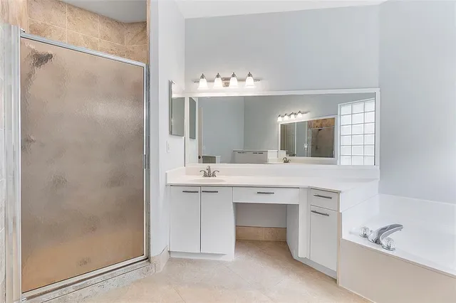 a bathroom with a double vanity sink mirror and shower