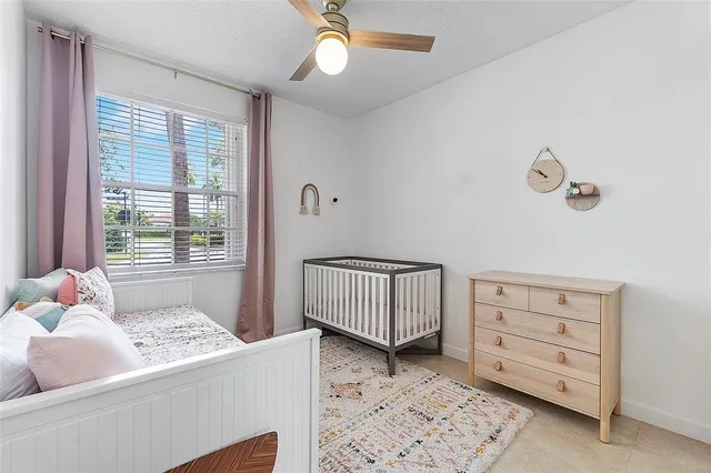 a bedroom with a baby bed baby crib and a dresser