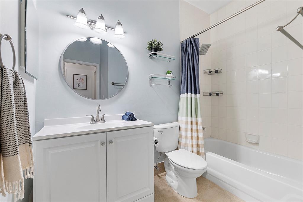 10650 Northwest 48th Street Coral Springs, FL 33076 - Photo 30 of 37 a bathroom with a toilet sink and mirror