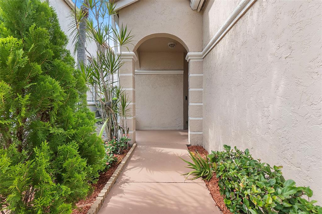10650 Northwest 48th Street Coral Springs, FL 33076 - Photo 3 of 37 a view of entryway with flower plants