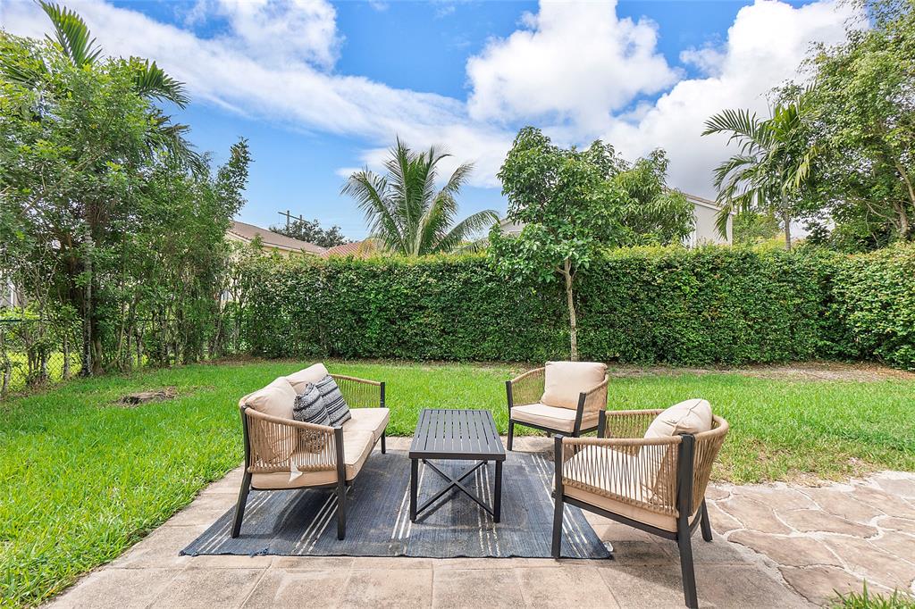 10650 Northwest 48th Street Coral Springs, FL 33076 - Photo 32 of 37 a view of a chair and table in the garden