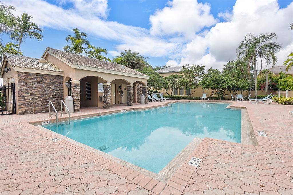 10650 Northwest 48th Street Coral Springs, FL 33076 - Photo 37 of 37 a view of a house with swimming pool and a yard