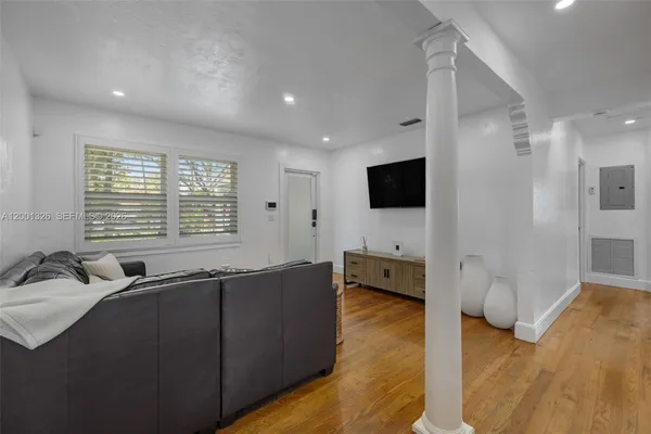 a living room with furniture and a flat screen tv
