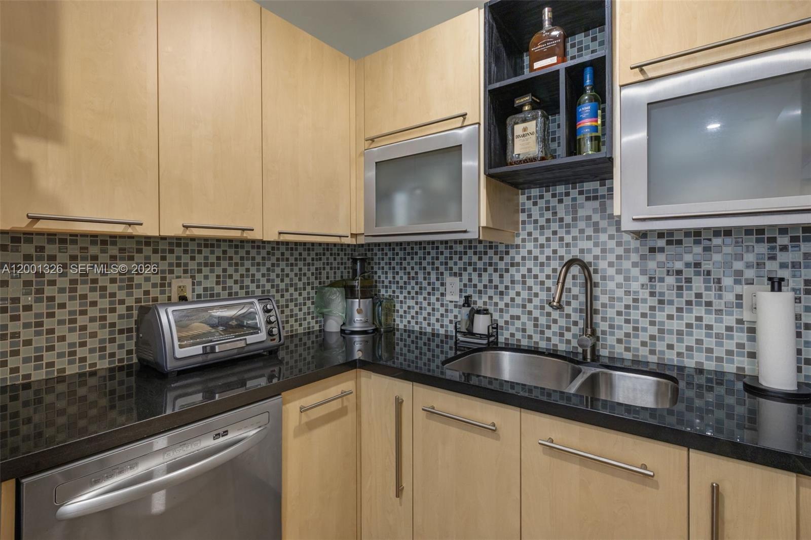 6382 Southwest 38th Street Miami, FL 33155 - Photo 15 of 41 a kitchen with sink a microwave and cabinets