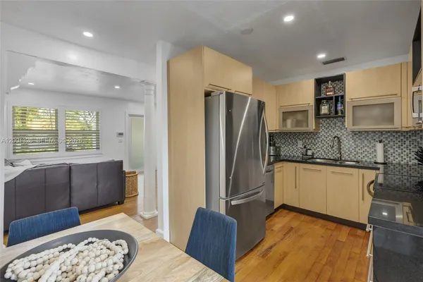 a kitchen with stainless steel appliances granite countertop a refrigerator and a stove top oven