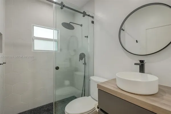 a bathroom with a sink toilet and shower