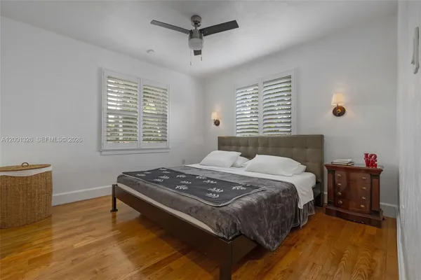 a bed sitting in a bedroom next to a window