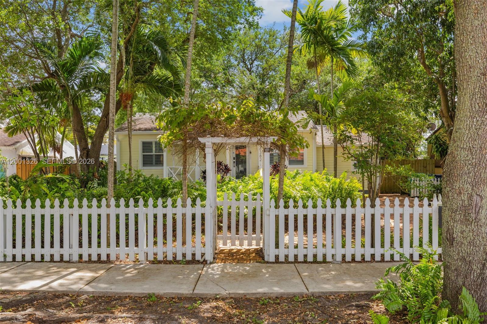 6382 Southwest 38th Street Miami, FL 33155 - Photo 2 of 41 a front view of a house with a garden