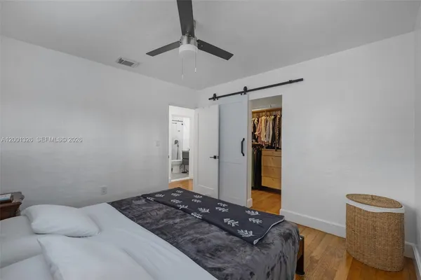 a bedroom with a bed and a walk in closet