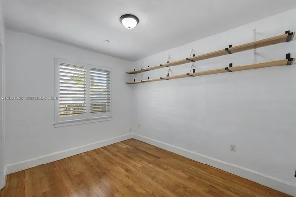 a view of an empty room with a window