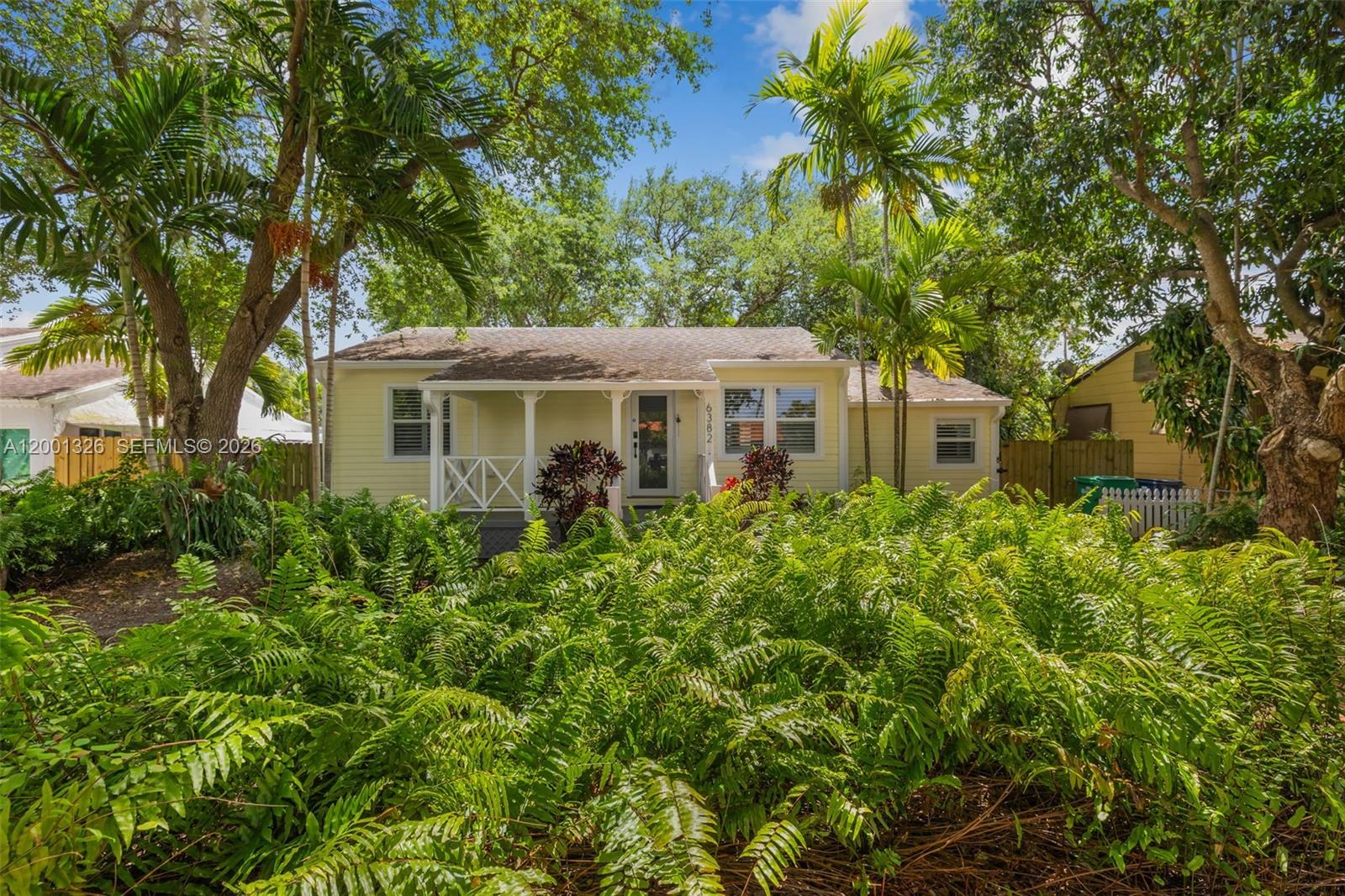 6382 Southwest 38th Street Miami, FL 33155 - Photo 3 of 41 a front view of a house with a yard