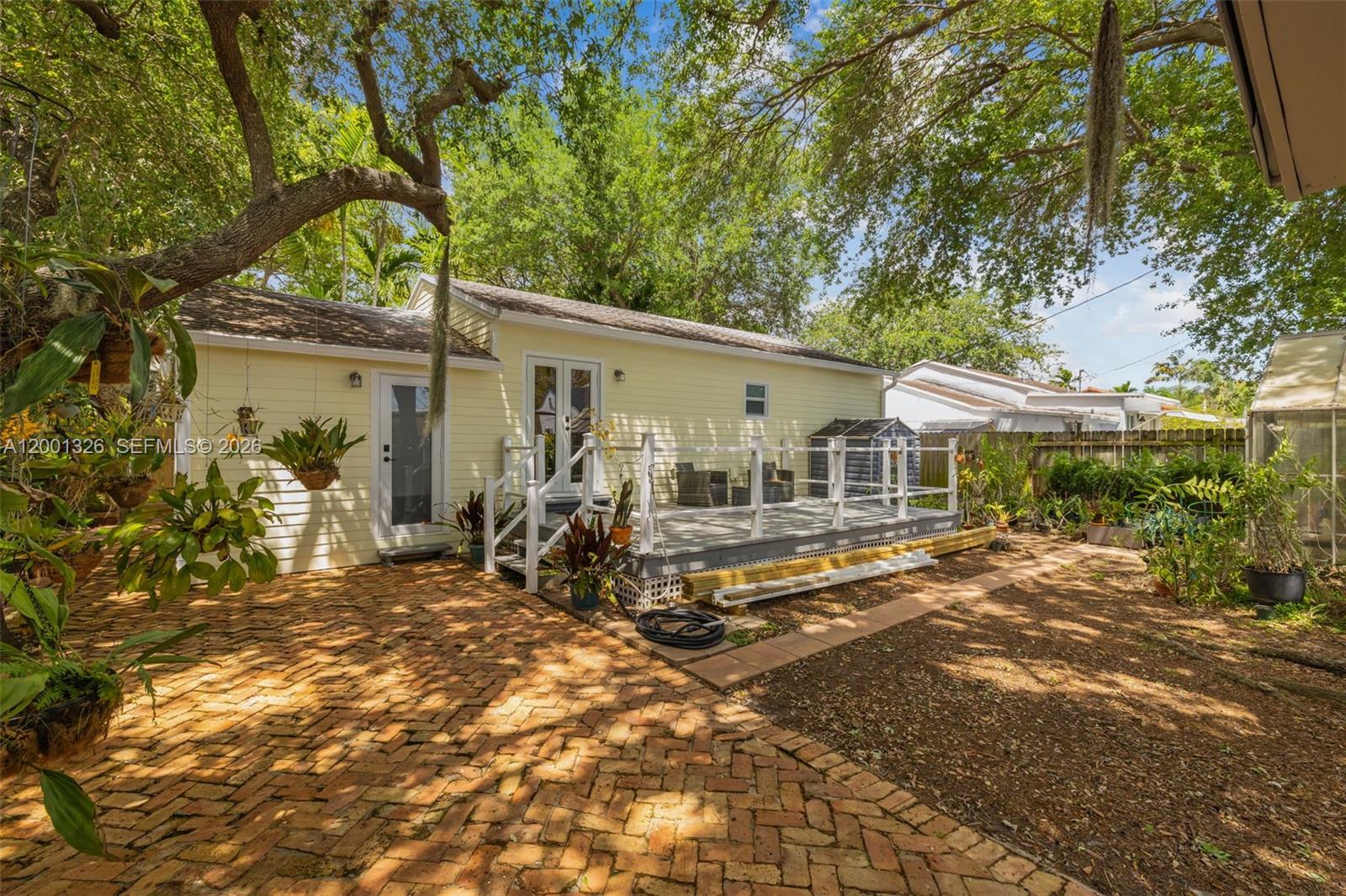 6382 Southwest 38th Street Miami, FL 33155 - Photo 31 of 41 a view of a house with backyard sitting area and garden