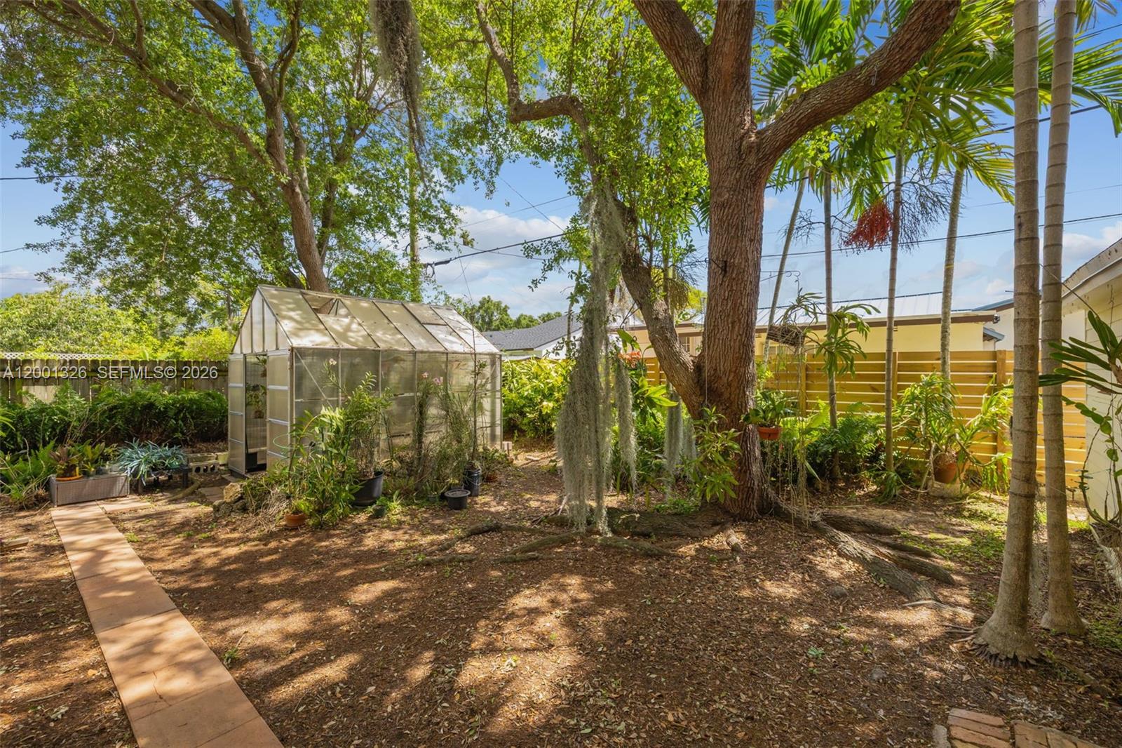 6382 Southwest 38th Street Miami, FL 33155 - Photo 32 of 41 a view of a yard with plants and trees