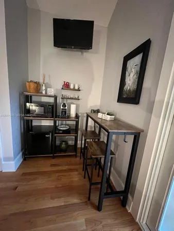 a view of a workspace with furniture and a flat screen tv