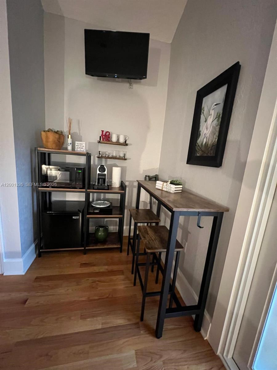 6382 Southwest 38th Street Miami, FL 33155 - Photo 38 of 41 a view of a workspace with furniture and a flat screen tv