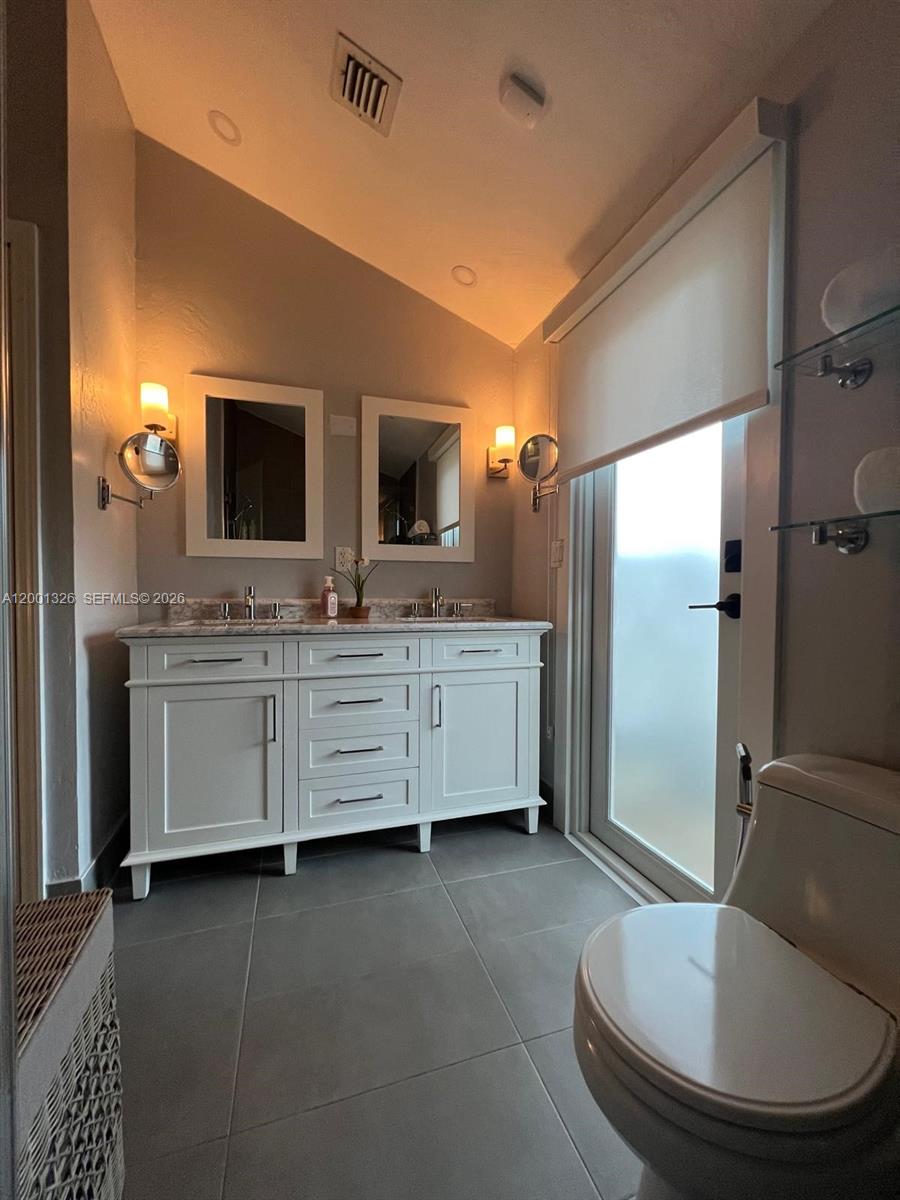 6382 Southwest 38th Street Miami, FL 33155 - Photo 39 of 41 a bathroom with a double vanity sink mirror and toilet