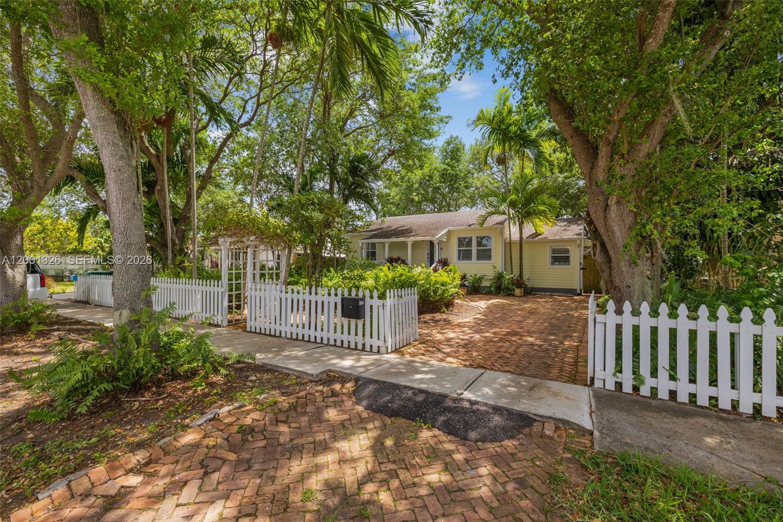 6382 Southwest 38th Street Miami, FL 33155 - Photo 4 of 41 a view of a house with a small yard and a large tree