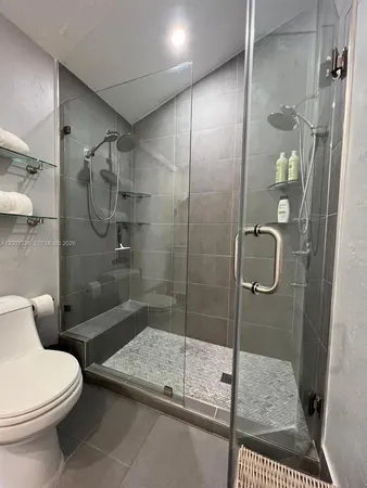 a bathroom with a toilet and shower