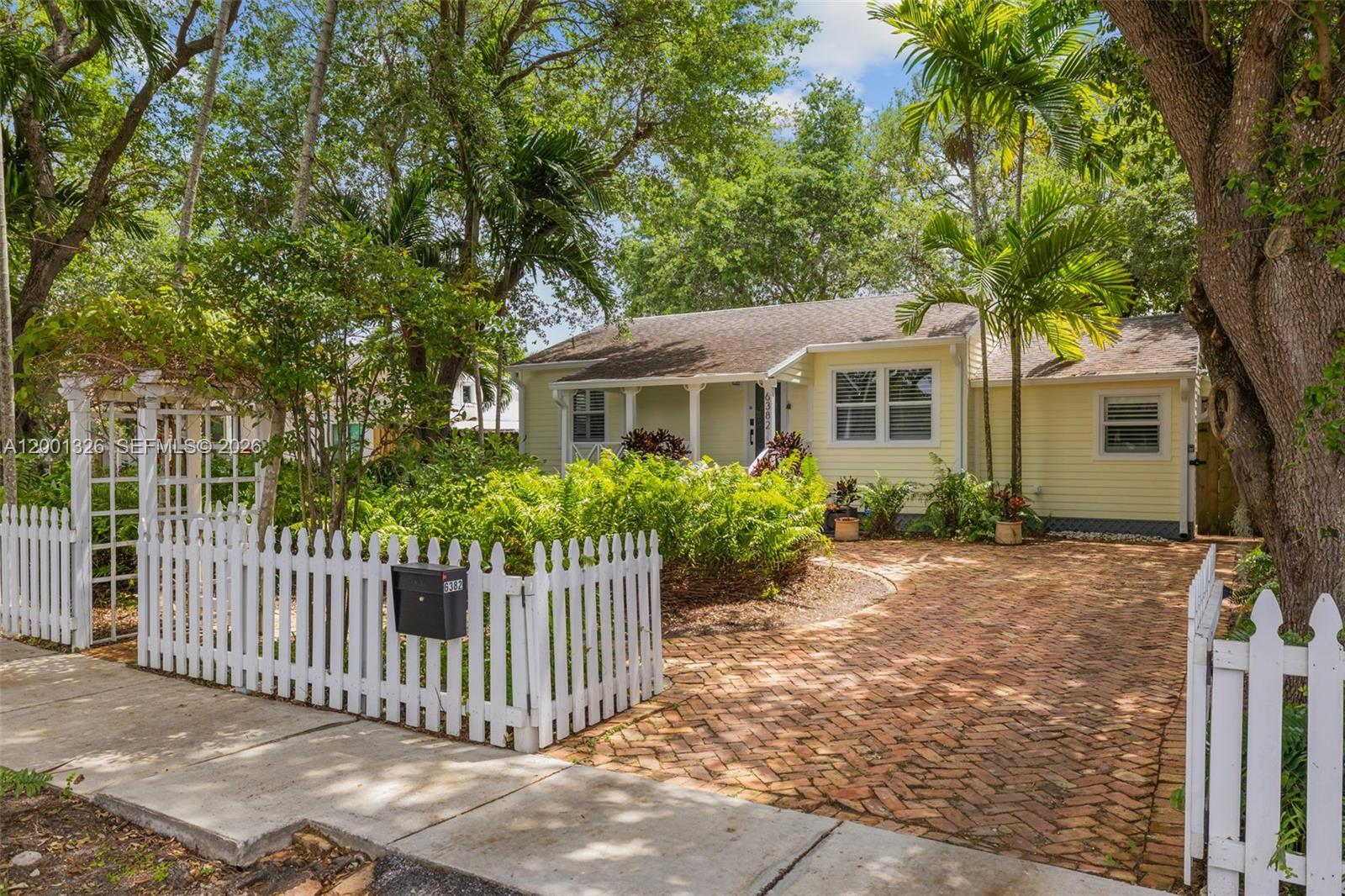 6382 Southwest 38th Street Miami, FL 33155 - Photo 5 of 41 a front view of a house with a porch