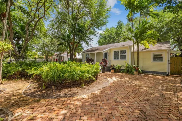 a view of a house with a tree in the background