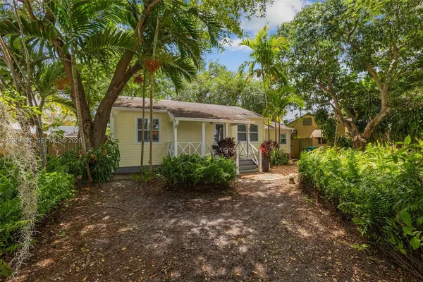 a view of a house with a tree in the background
