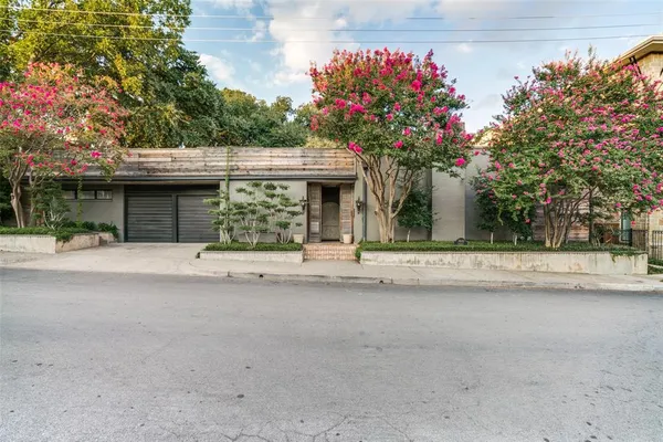 a view of a house with a yard and a garage