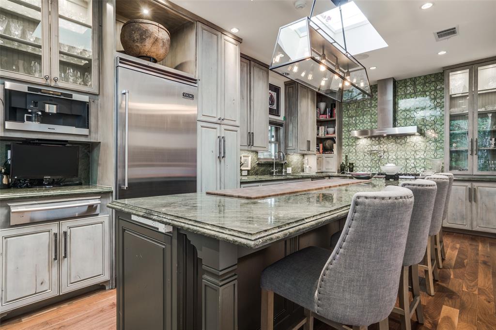 3610 Congress Avenue Dallas, TX 75219 - Photo 12 of 40 a kitchen with stainless steel appliances granite countertop a stove a sink and a refrigerator
