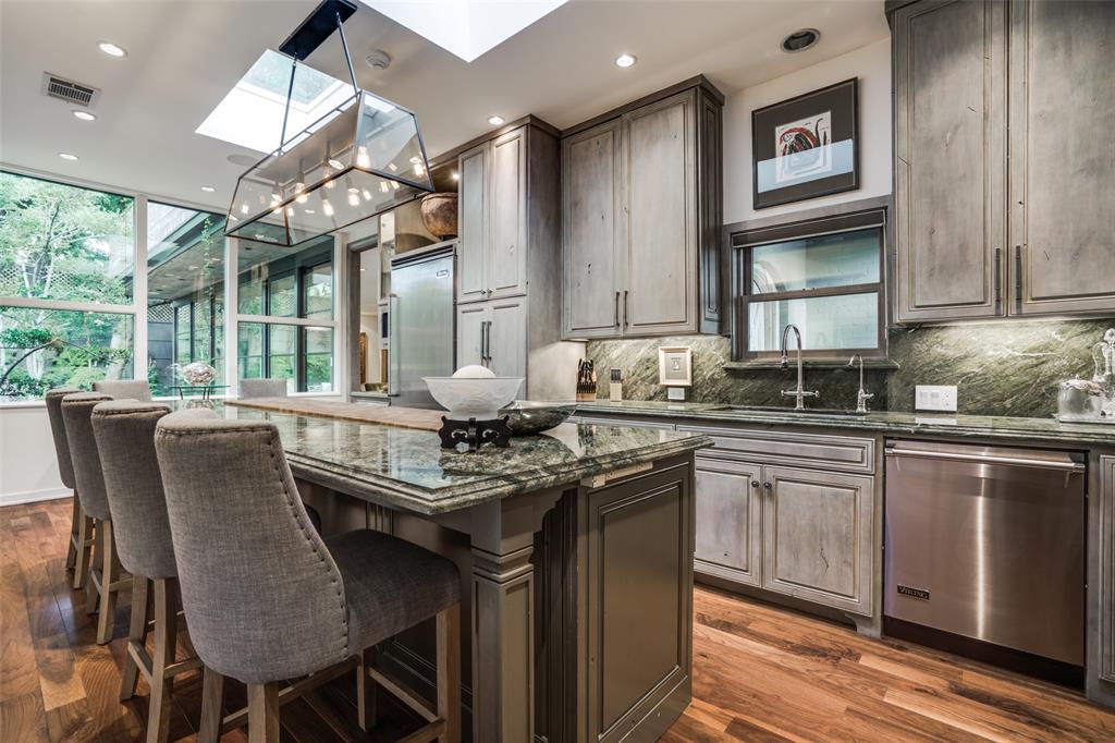 3610 Congress Avenue Dallas, TX 75219 - Photo 14 of 40 a kitchen with stainless steel appliances granite countertop a stove a sink dishwasher and a refrigerator with wooden floor