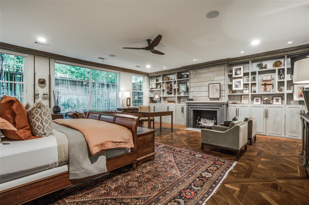 3610 Congress Avenue Dallas, TX 75219 - Photo 18 of 40 a bedroom with a large bed and a fireplace