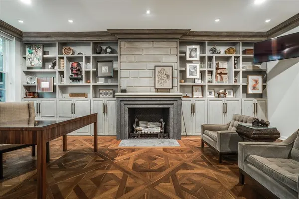 a living room with furniture a fireplace and a book shelf