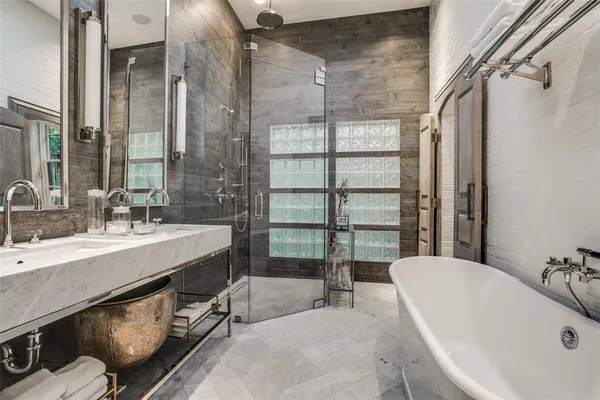 a bathroom with a tub sink and mirror